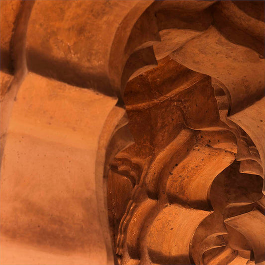 At the magic hour of sunset, the Lotus Mahal undergoes a transformation. The orange hues of the setting sun bathe the stone carvings in a warm and vibrant light, revealing a hidden layer of beauty within the ancient walls. "Golden Hour Whispers" captures this fleeting moment, when the sun's last rays ignite the carvings and bring them to life.