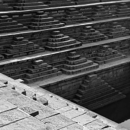 Step well carved in a stone. Hampi, a World Heritage Site situated in Karnataka, India. (0132) This is located at Mahanavmi Dibba, Hampi. Indian Heritage, Art and Culture. A beautiful composition of the steps, pattern and beautiful play of light and shadows. This Fine Art Photograph is printed on Canvas. Fine Art Photography on Canvas Printing Indian Temples Fine Art Culture Carving Stone Black and White black&white B&W World Heritage Site BW Hampi