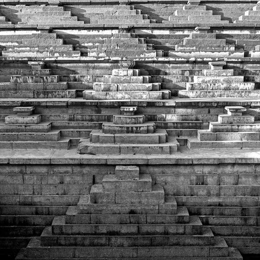 Step well carved in a stone. Hampi, a World Heritage Site situated in Karnataka, India. (0132) This is located at Mahanavmi Dibba, Hampi. Indian Heritage, Art and Culture. A beautiful composition of the steps, pattern and beautiful play of light and shadows. This Fine Art Photograph is printed on Canvas. Fine Art Photography on Canvas Printing Indian Temples Fine Art Culture Carving Stone Black and White black&white B&W World Heritage Site BW Hampi Abstract
