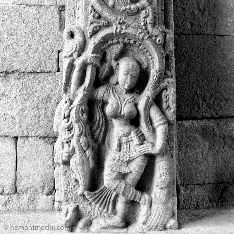 Lady (Shalbhajika) at the temple entrance. (0219Hampi) Hampi, a World Heritage Site situated in  Karnataka, India. This is located at Mahanavmi Dibba, Hampi. Indian Heritage, Art and Culture.  Fine Art Photography on Canvas Printing Indian Temples Fine Art Culture Carving Stone Black and White black&white B&W World Heritage Site BW Hampi 
